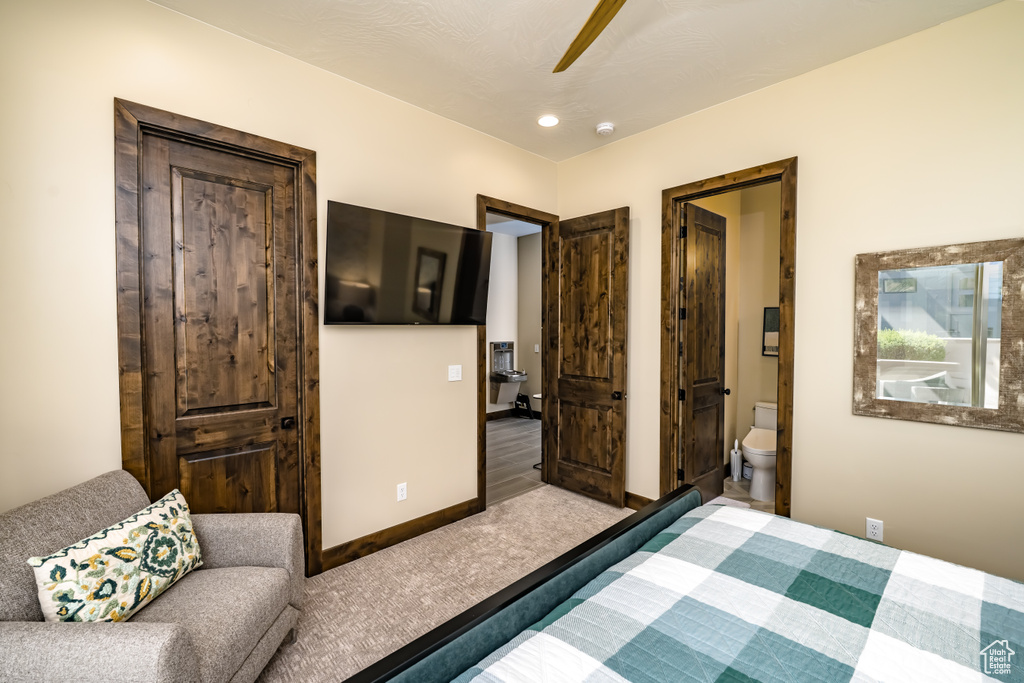 Bedroom with baseboards, ceiling fan, ensuite bath, and recessed lighting
