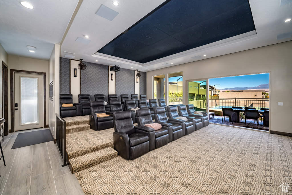 Home theater featuring a tray ceiling, baseboards, and recessed lighting