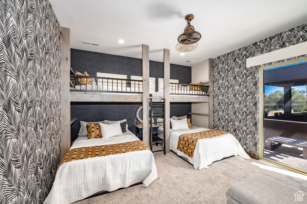 Bedroom featuring carpet floors, wallpapered walls, and visible vents