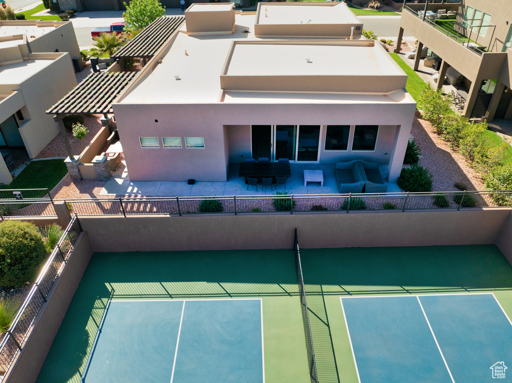 Exterior space with a patio area, stucco siding, outdoor lounge area, and fence