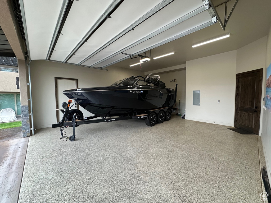 Garage with electric panel and baseboards