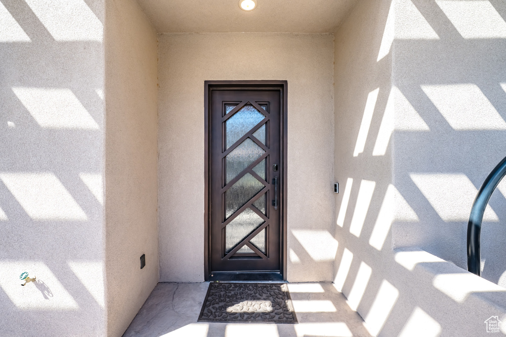 Doorway to property with stucco siding