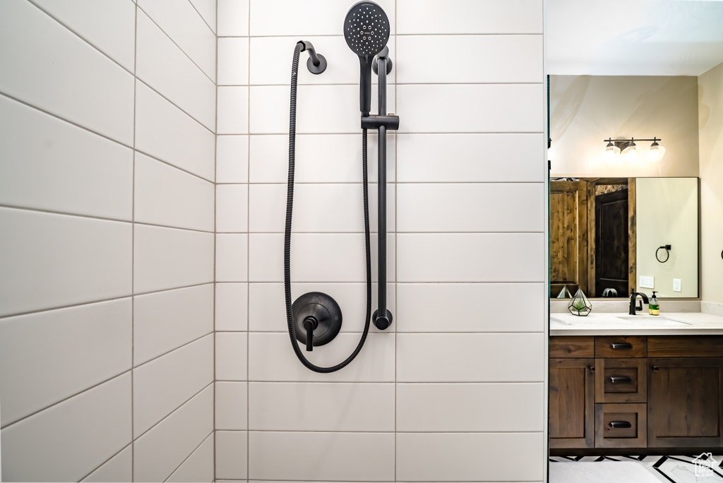 Full bathroom featuring vanity and tiled shower