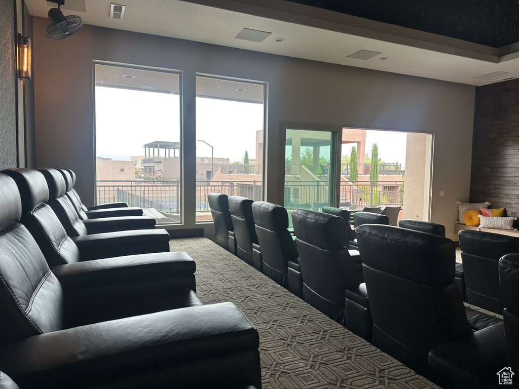 Cinema with carpet, plenty of natural light, and visible vents