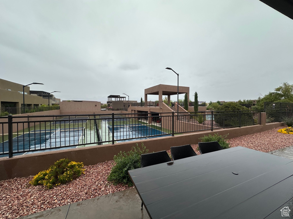 View of pool featuring fence, a patio area, and a swimming pool