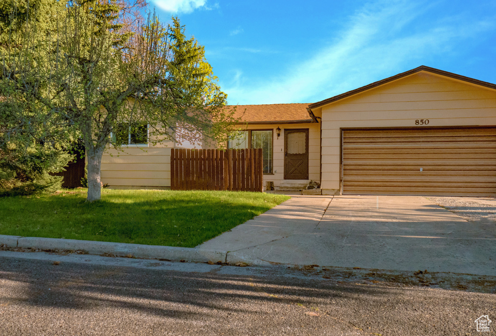 Ranch-style home with a garage and driveway