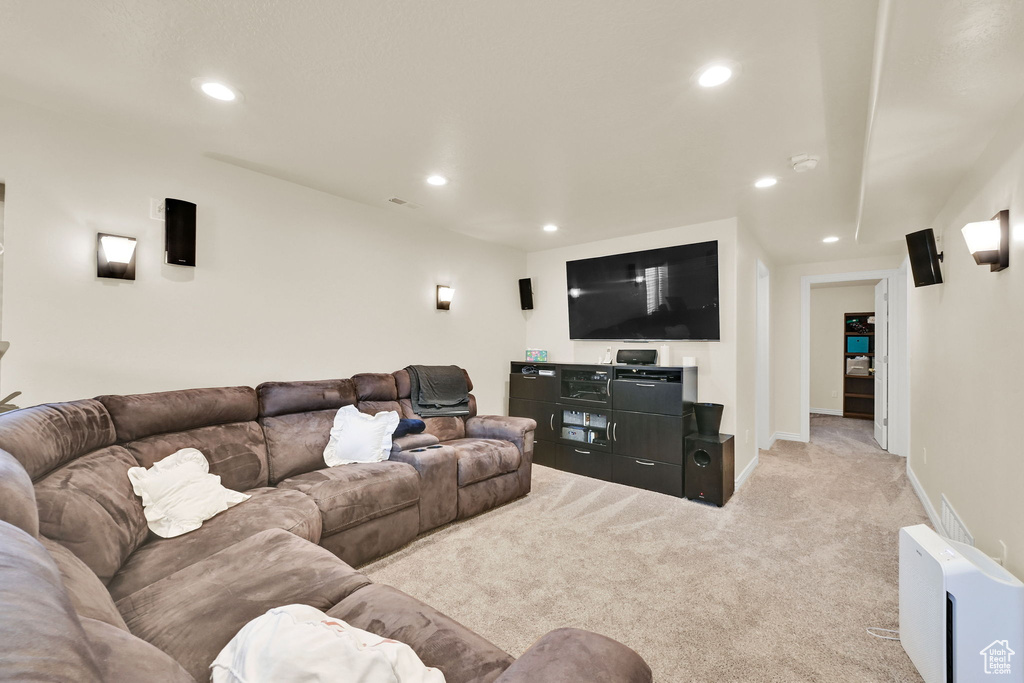 Living area featuring baseboards, recessed lighting, and light colored carpet