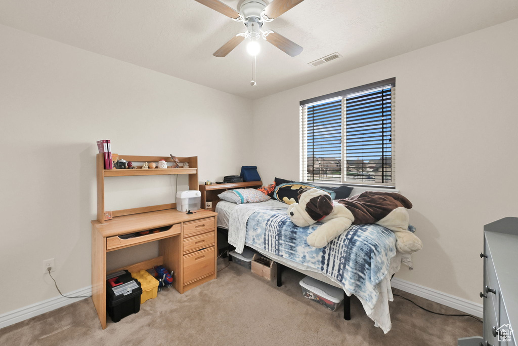 Bedroom with a ceiling fan, light carpet, baseboards, and visible vents