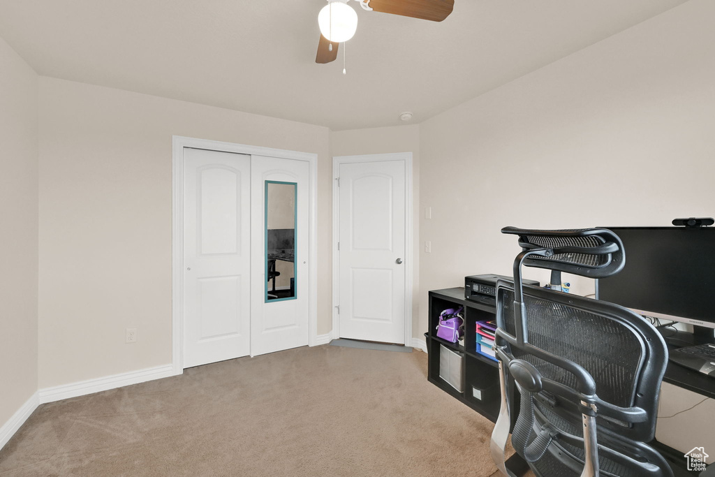 Carpeted office space with baseboards and ceiling fan
