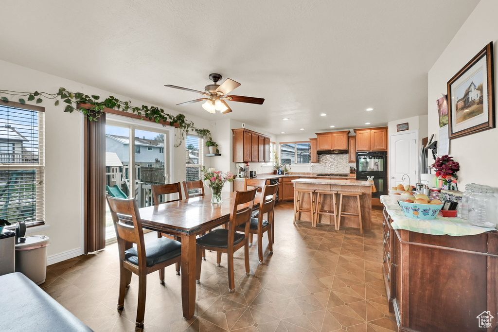 Dining area featuring recessed lighting, a wealth of natural light, baseboards, and ceiling fan