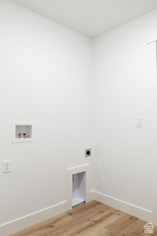 Laundry area with hookup for a washing machine, light wood finished floors, baseboards, laundry area, and electric dryer hookup