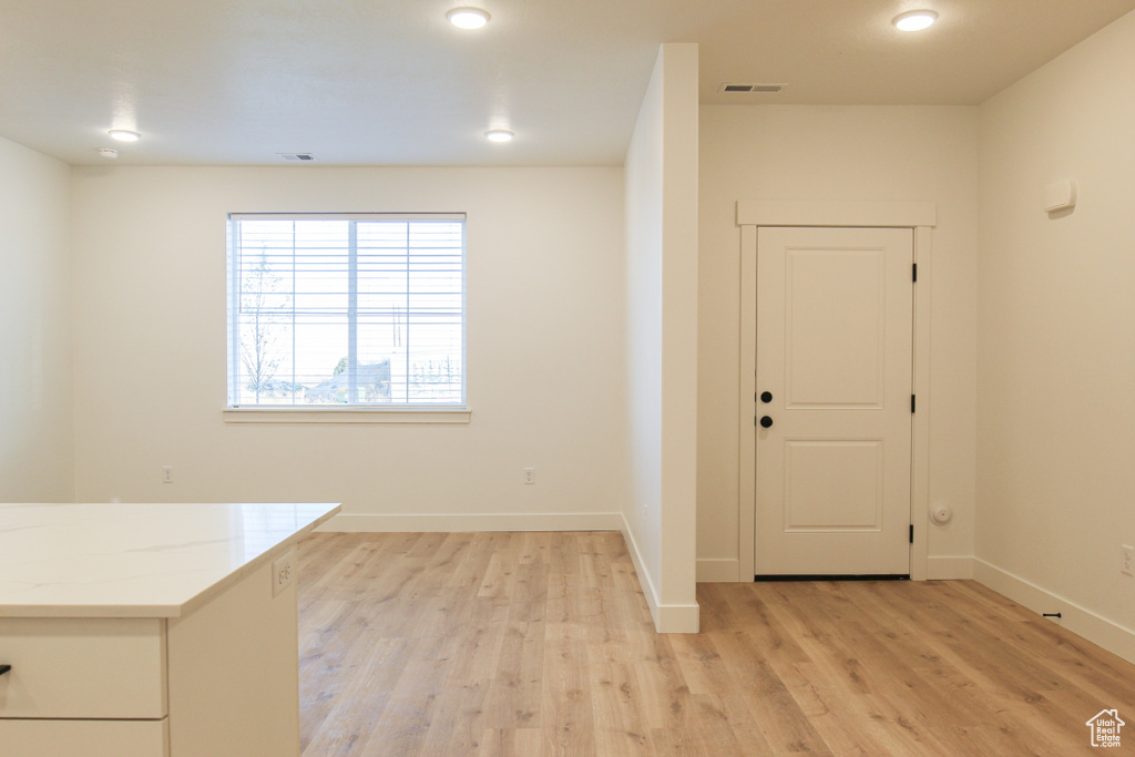 Foyer with baseboards, visible vents, and light wood-style flooring