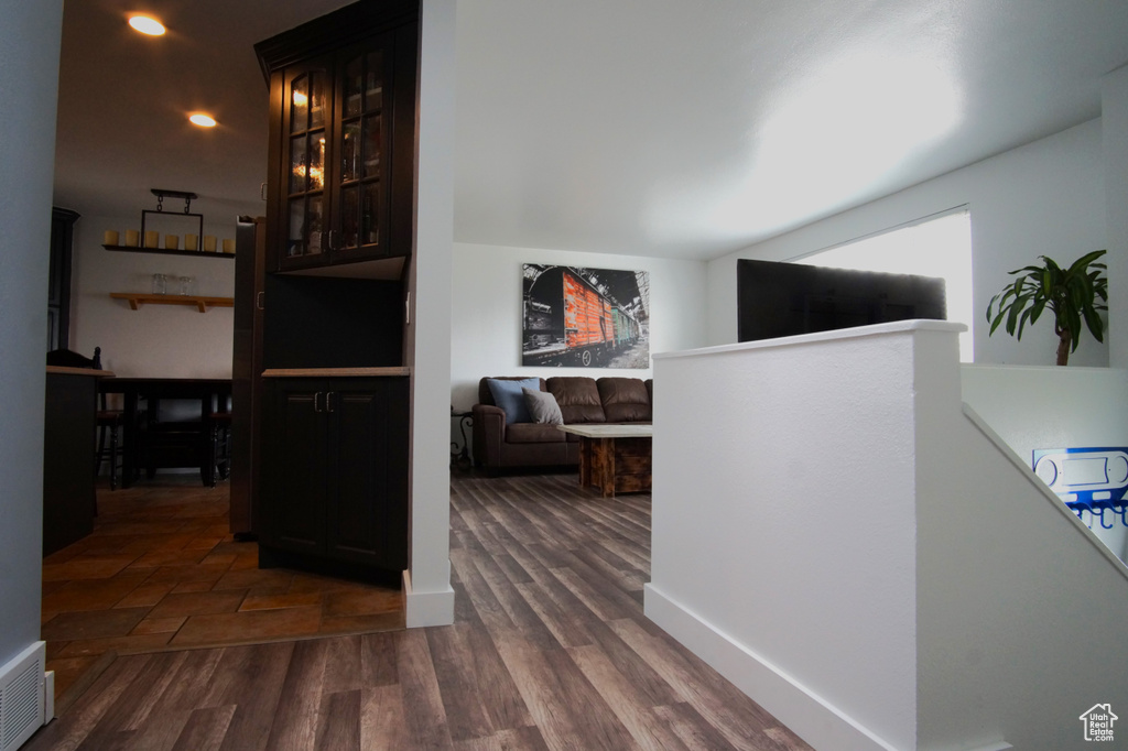 Hall with dark wood-style flooring and visible vents