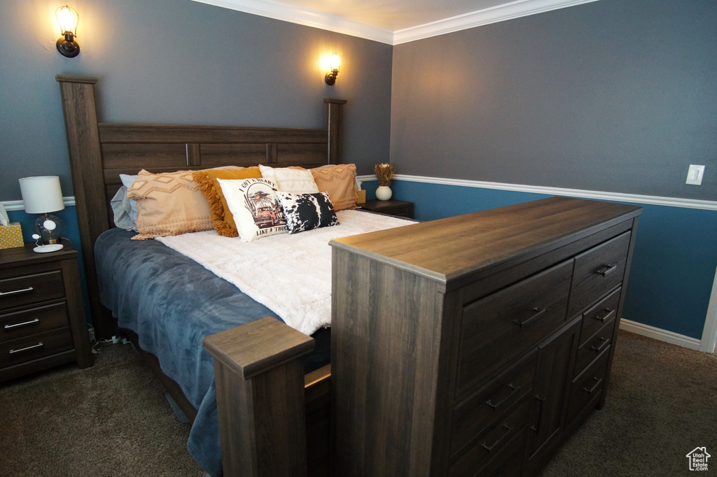 Bedroom with ornamental molding, baseboards, and dark carpet