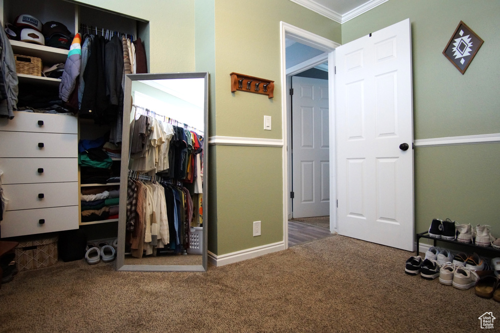 Carpeted bedroom with baseboards and crown molding