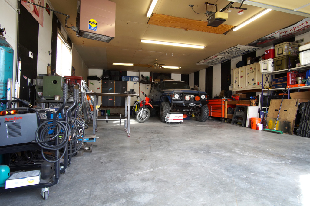 Garage featuring a workshop area and a garage door opener