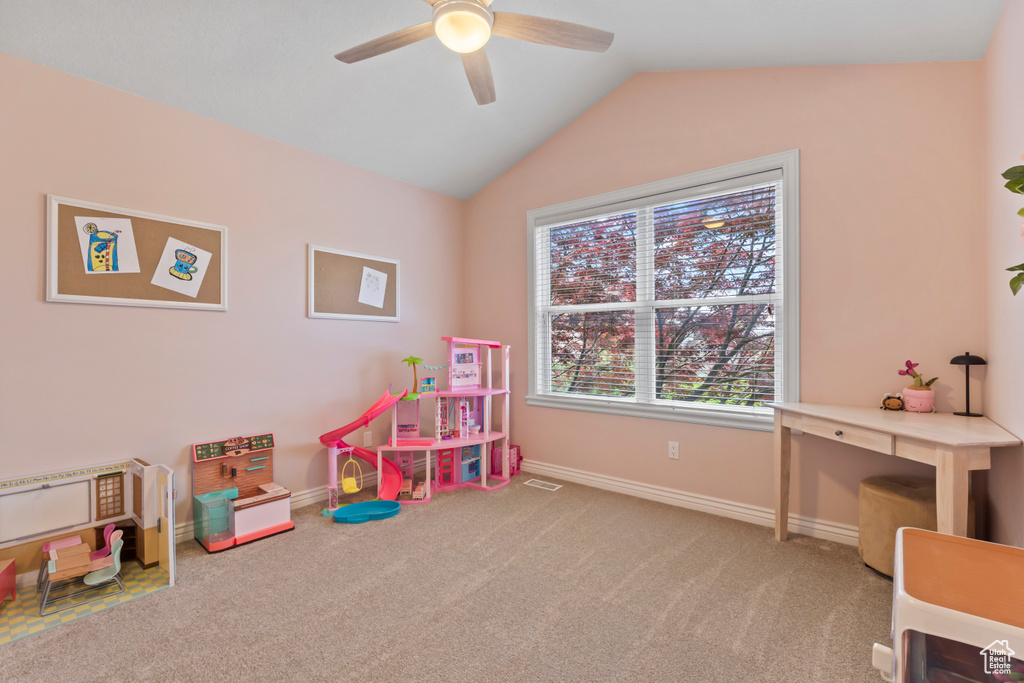 Game room with a ceiling fan, carpet, lofted ceiling, and baseboards