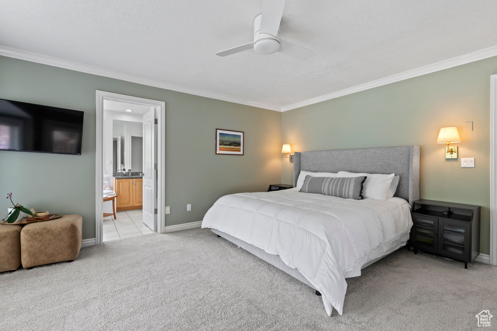 Bedroom featuring crown molding, carpet flooring, baseboards, connected bathroom, and a ceiling fan
