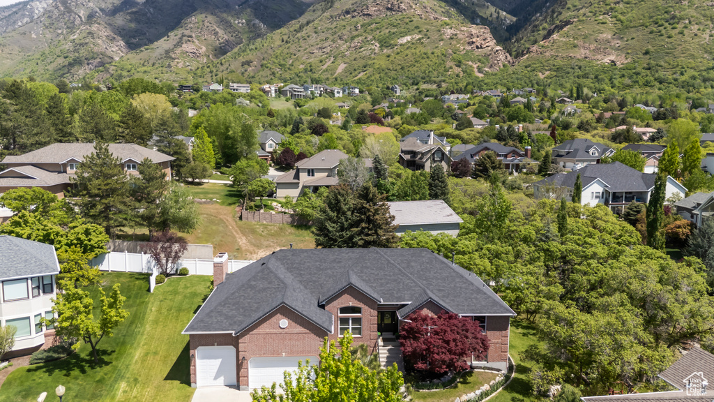 Aerial perspective of suburban area featuring a mountainous background