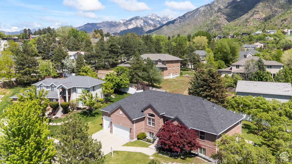 Aerial view of residential area featuring a mountainous background