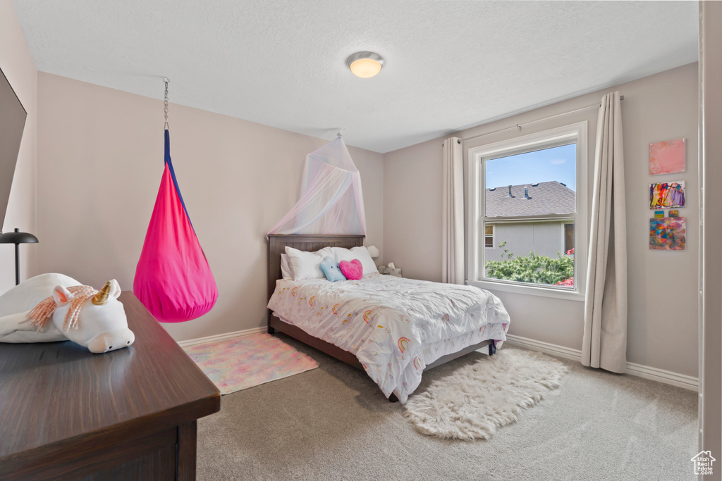 Carpeted bedroom with baseboards