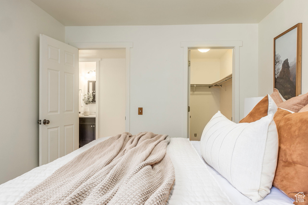 Bedroom featuring a walk in closet and a closet