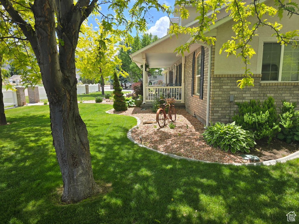 View of green lawn with a porch