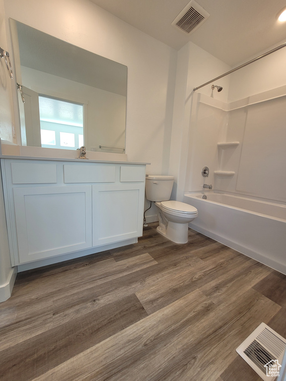 Bathroom with vanity, tub / shower combination, and wood finished floors
