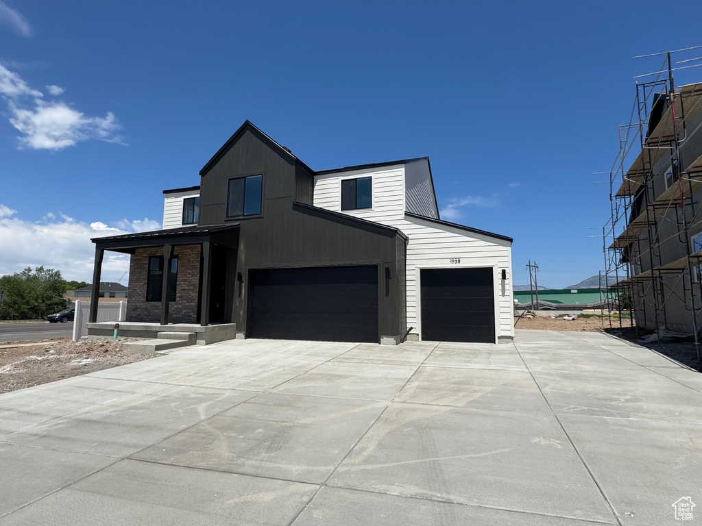Modern home featuring driveway, a garage, and an attached garage