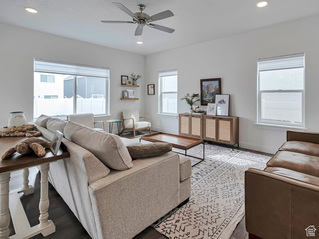 Living area with baseboards, light wood-style flooring, ceiling fan, and recessed lighting
