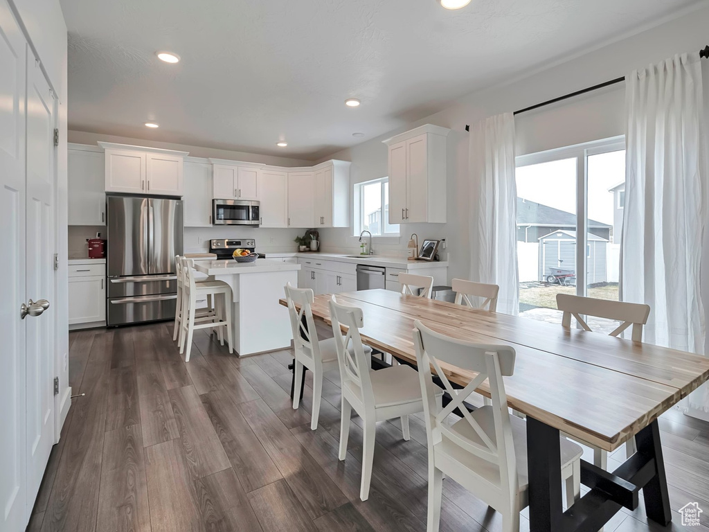 Dining area with recessed lighting, dark wood-type flooring, baseboards, and visible vents