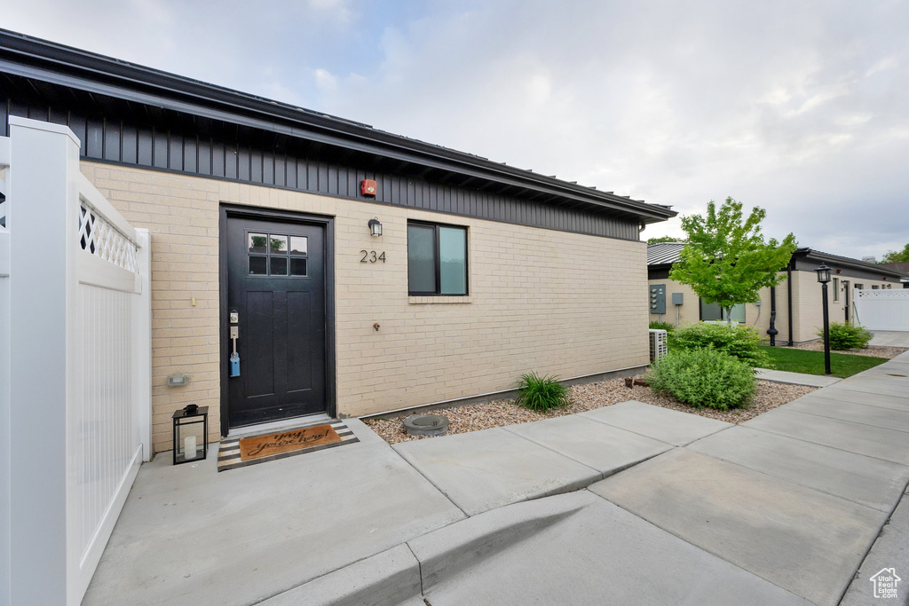 View of exterior entry with brick siding