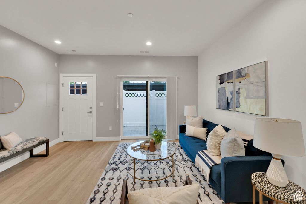 Living area featuring light wood-type flooring, recessed lighting, and baseboards