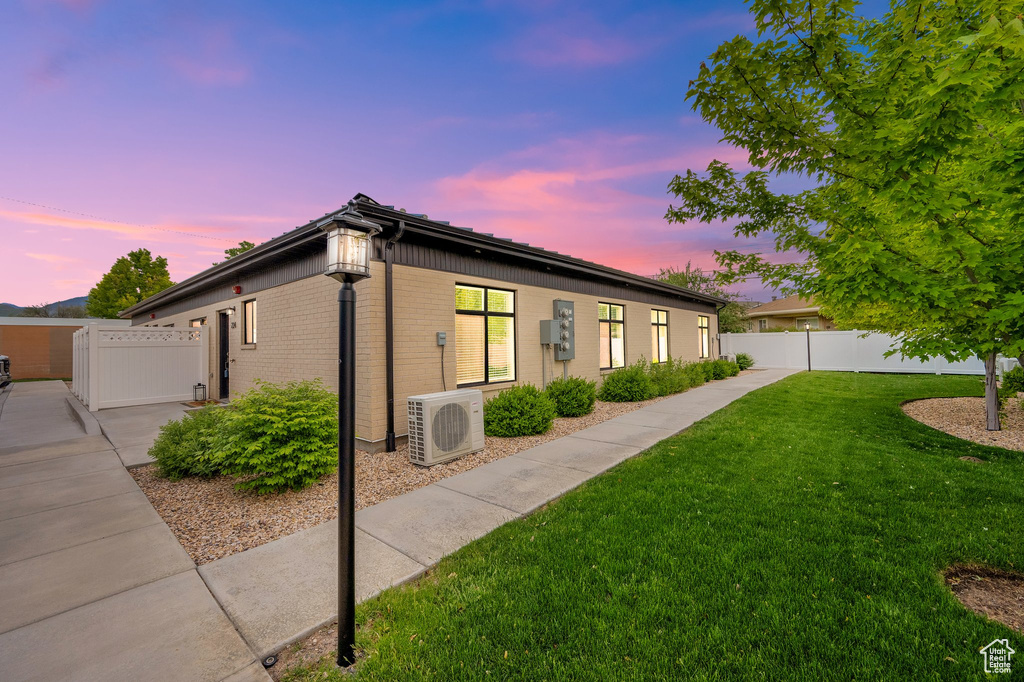 View of side of property with ac unit and brick siding