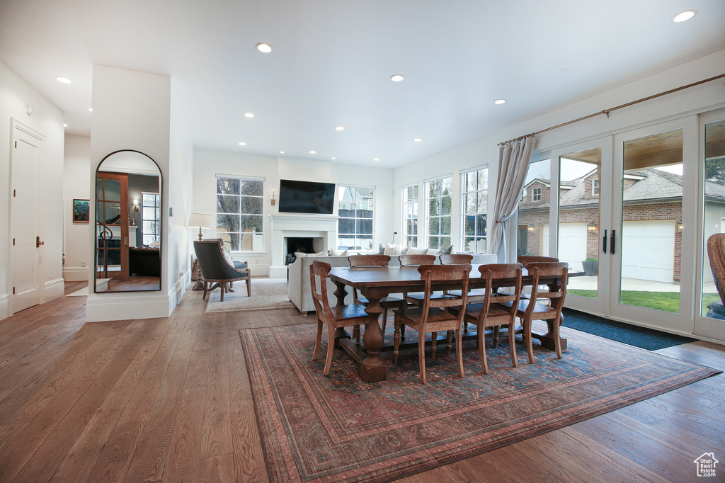 Dining space featuring a fireplace, recessed lighting, and hardwood / wood-style flooring
