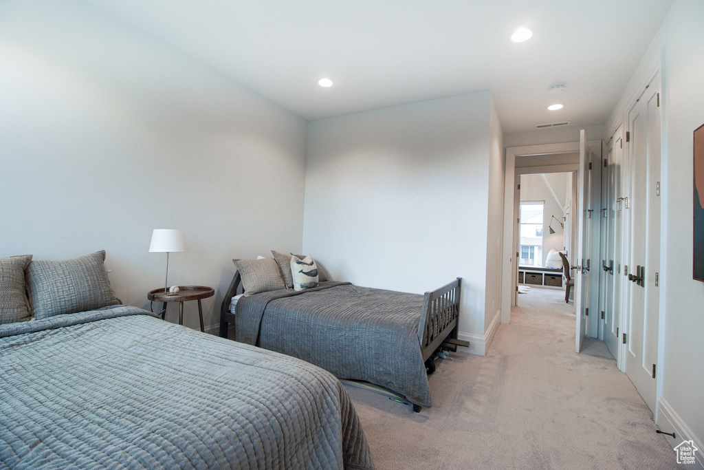 Bedroom featuring light carpet, baseboards, and recessed lighting