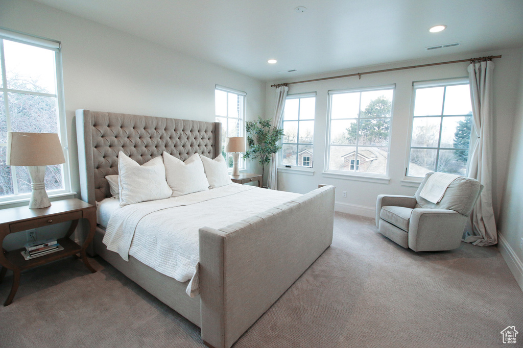 Bedroom with light carpet, baseboards, and recessed lighting