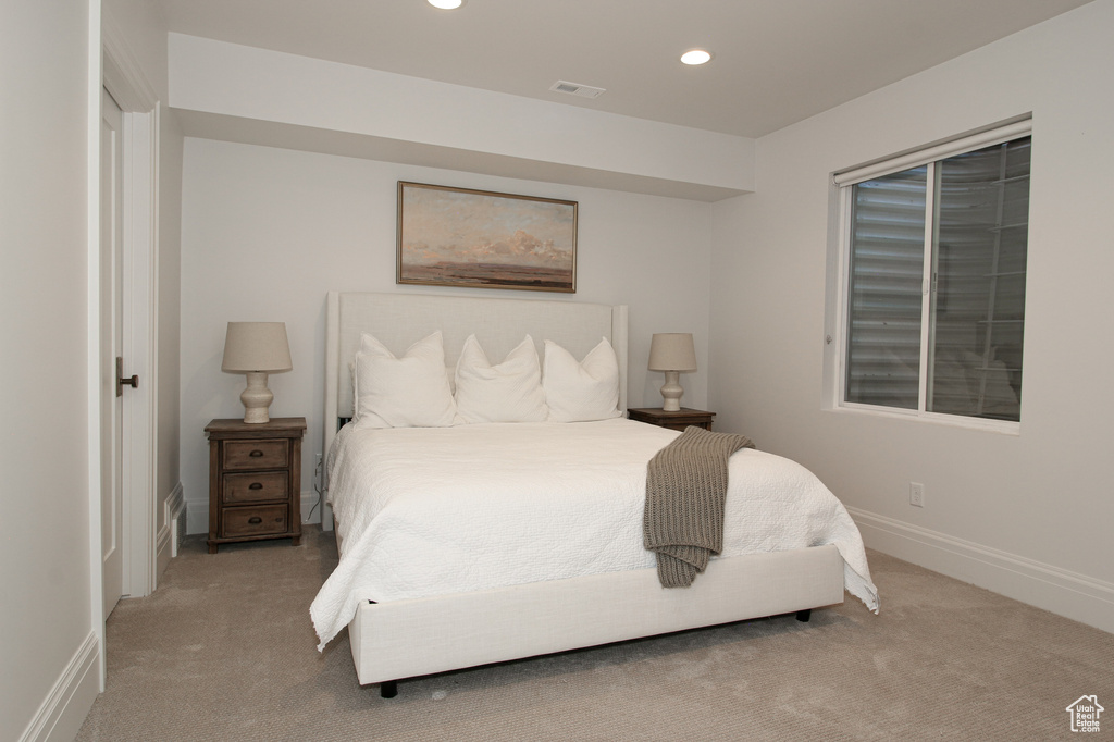 Carpeted bedroom featuring recessed lighting, baseboards, and visible vents