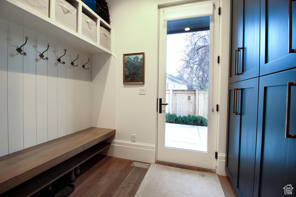 Mudroom with baseboards and wood finished floors