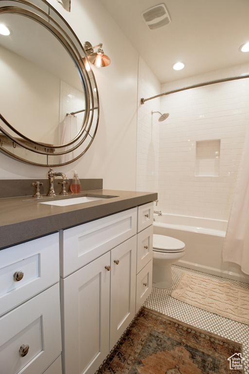 Full bath featuring tile patterned floors, toilet, vanity,  shower combination, and visible vents