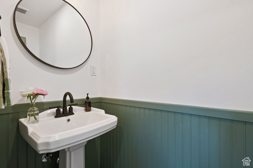 Bathroom with wainscoting and a sink