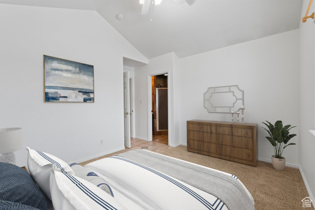 Bedroom featuring vaulted ceiling, baseboards, a ceiling fan, and light carpet
