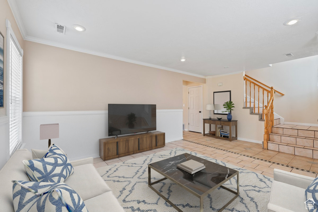 Living area featuring stairs, recessed lighting, light tile patterned floors, crown molding, and baseboards