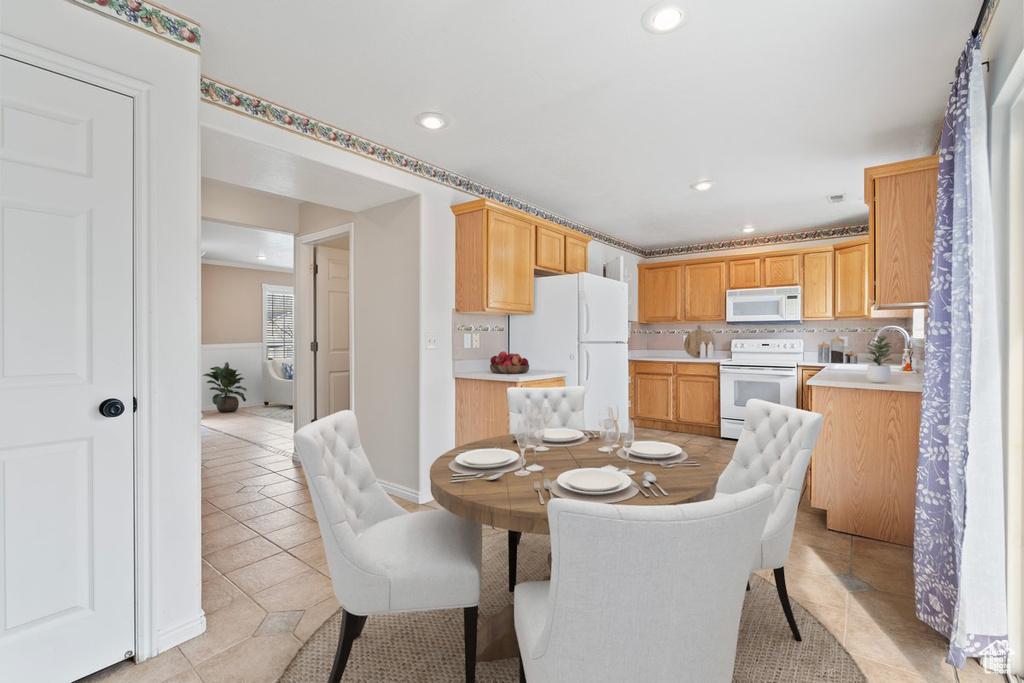 Dining space featuring recessed lighting and light tile patterned flooring
