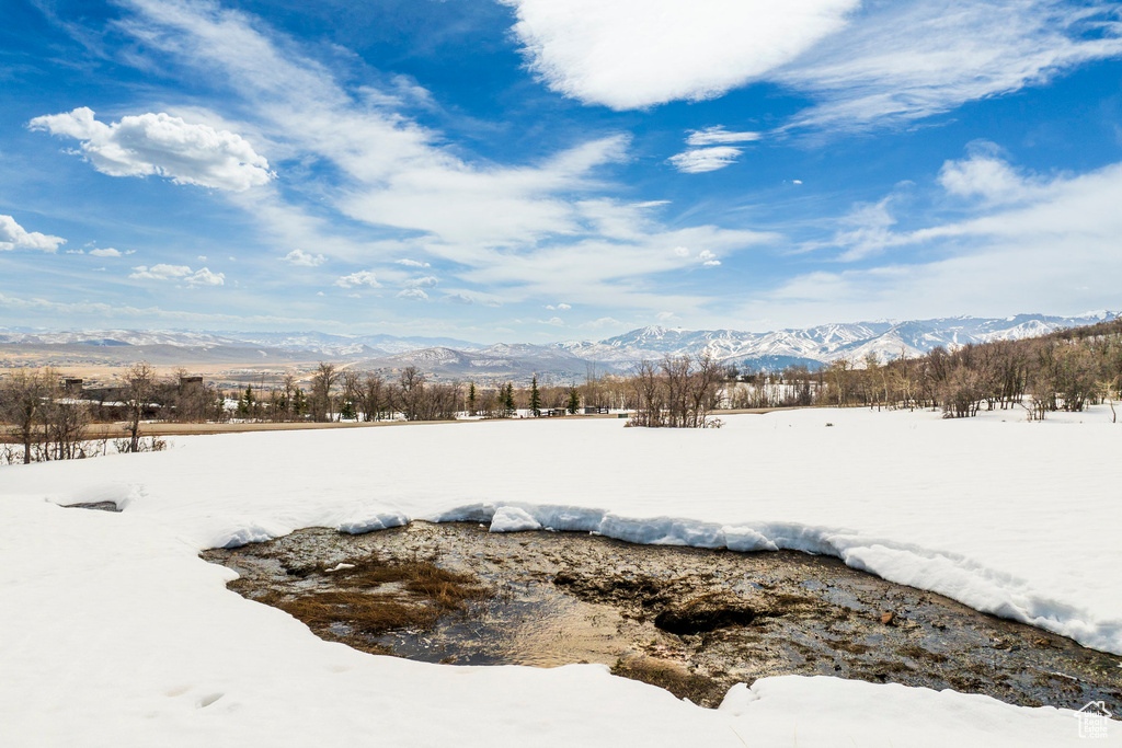 Snowy yard featuring a mountain view