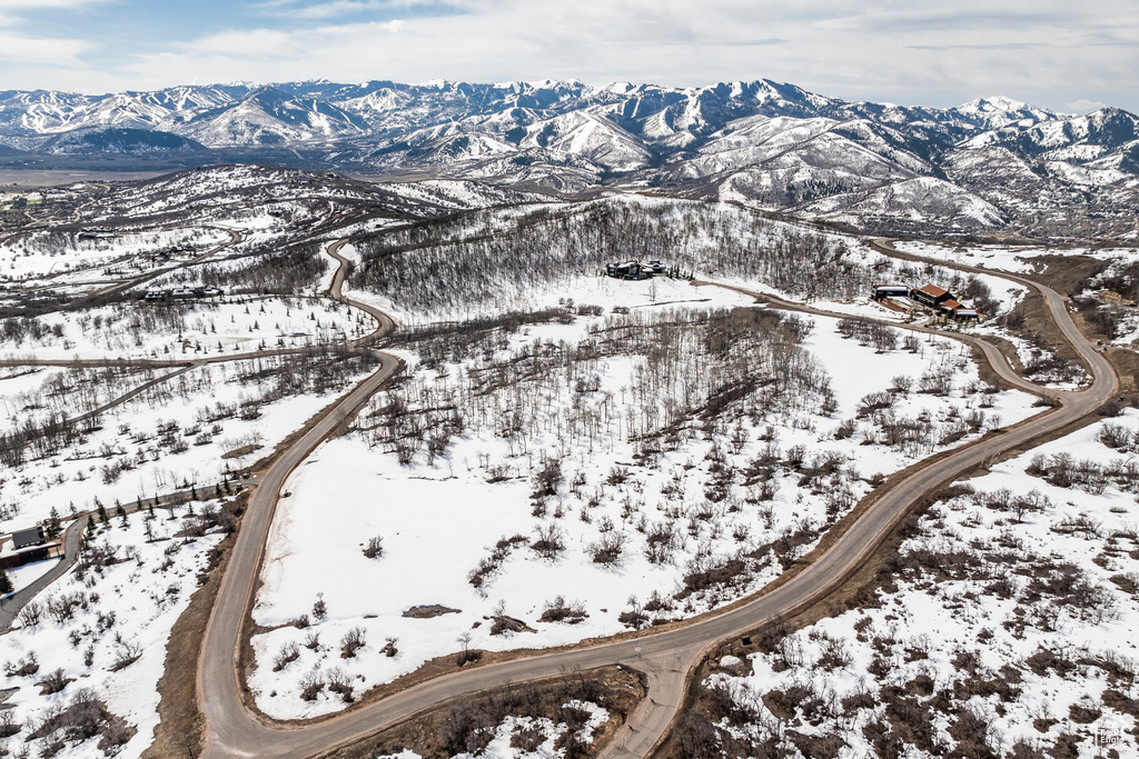 Snowy aerial view featuring a mountain view