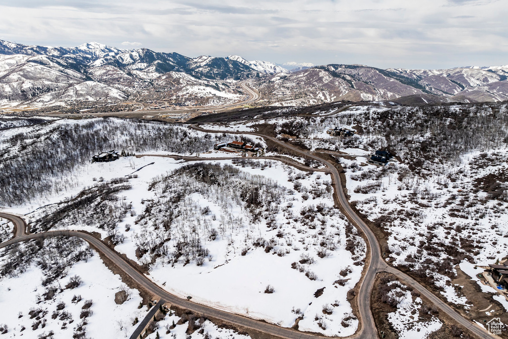 Snowy aerial view featuring a mountain view
