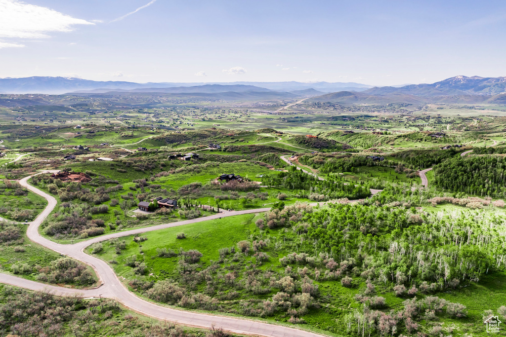 Aerial view of property and surrounding area featuring mountains