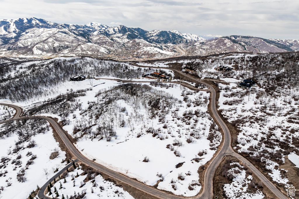 Snowy aerial view featuring a mountain view