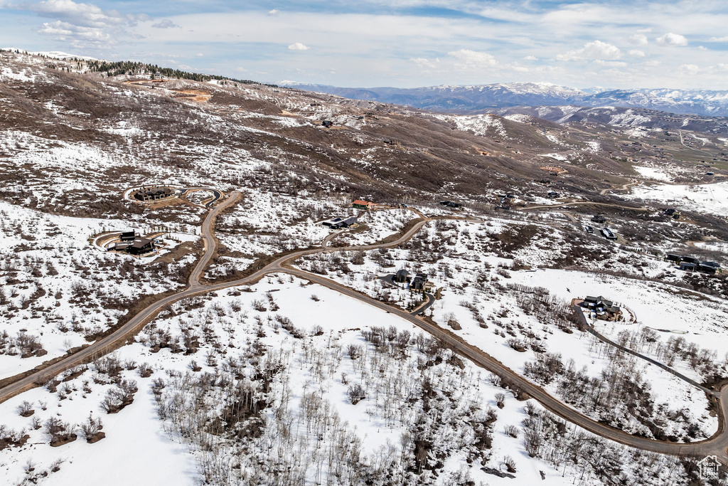 Snowy aerial view featuring a mountain view